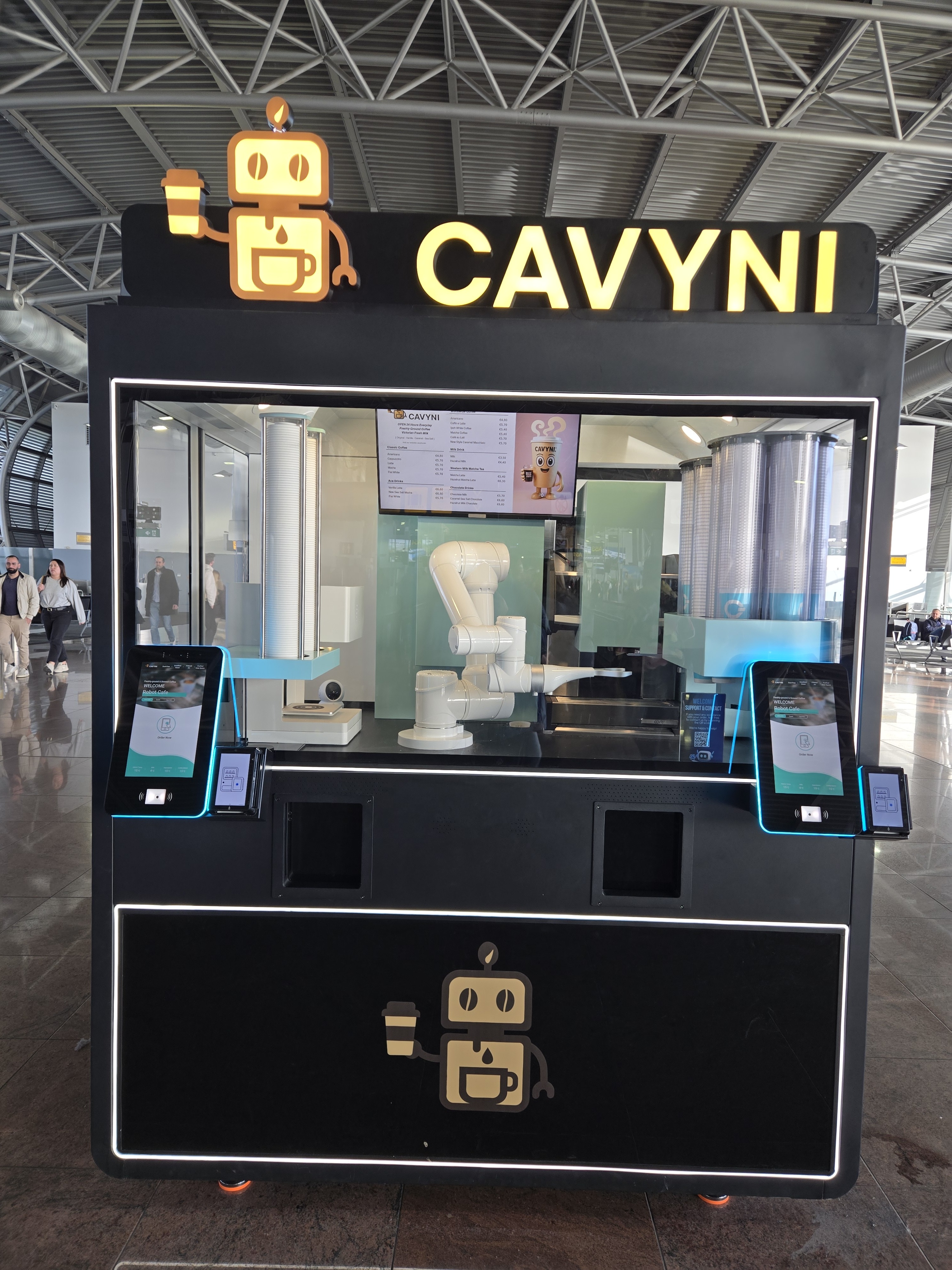 A robot arm preparing and selling coffee in an airport
